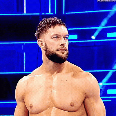 A Shirtless Wrestler With A Beard Is Standing In A Wrestling Ring . GIF
