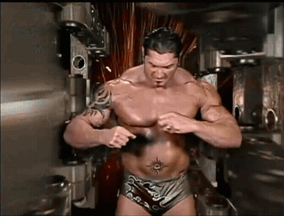 A Shirtless Wrestler With A Tattoo On His Stomach GIF