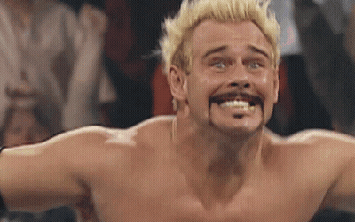 A Shirtless Wrestler With Blonde Hair And A Mustache Making A Funny Face GIF