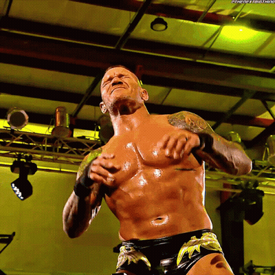 A Shirtless Wrestler With The Hashtag #Thenextbig Thing Written On The Bottom GIF