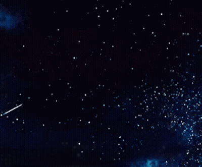 A Shooting Star Flies Through A Dark Night Sky GIF