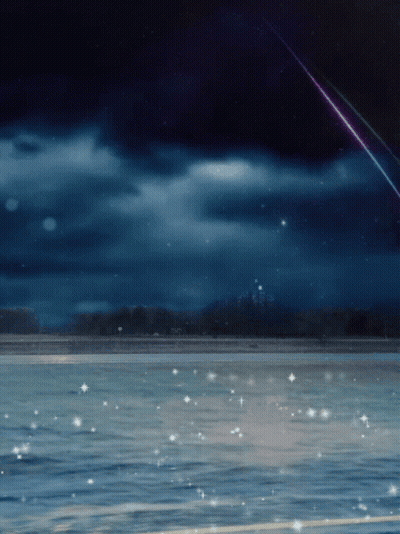 A Shooting Star Is Visible Over A Body Of Water At Night GIF