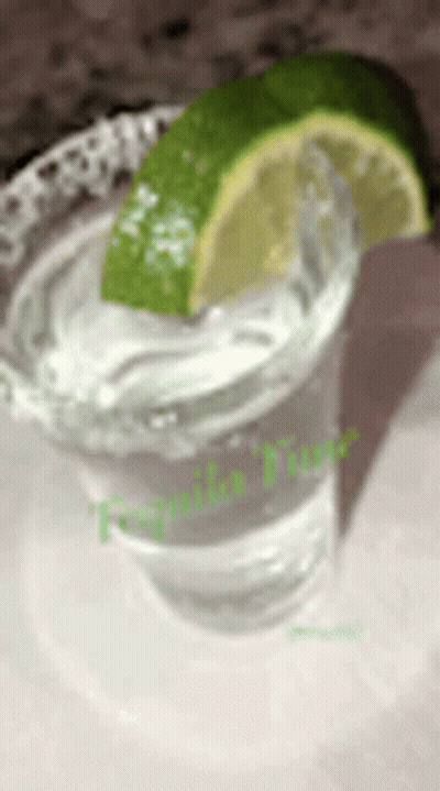 A Shot Glass Of Tequila With A Slice Of Lime On Top GIF
