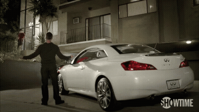A Showtime Ad Shows A Man Standing Next To A White Infiniti GIF