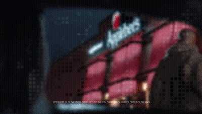 A Sign For Applebee 'S Is Lit Up In The Dark GIF