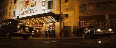 A Sign For Sean Connery Thunderball Hangs Above A Car GIF