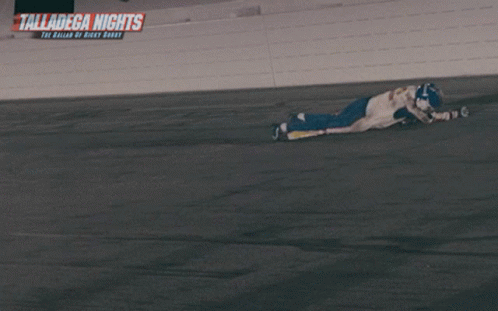 A Sign For Talladega Nights Hangs On A Wall GIF