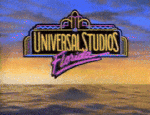 A Sign For Universal Studios Florida With A Sunset Background GIF