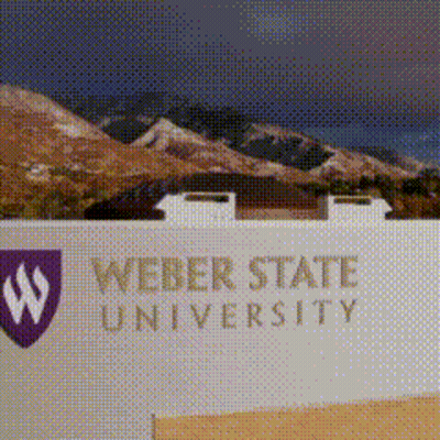 A Sign For Weber State University With A Picture Of Mountains Behind It GIF