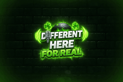 A Sign That Says Different Here For Real With A Microphone And Shamrocks GIF