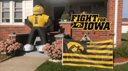A Sign That Says Fight For Iowa Is On A Brick House GIF