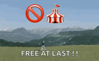 A Sign That Says Free At Last With A Red And White Tent In The Background GIF