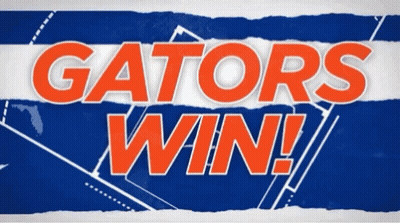 A Sign That Says Gators Win On A Blue And White Striped Background GIF
