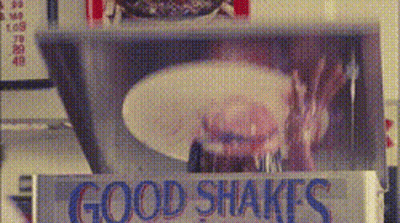 A Sign That Says Good Shakes In Blue GIF