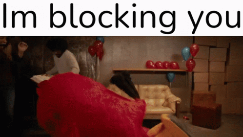 A Sign That Says I 'M Blocking You In Front Of A Couch GIF