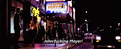 A Sign That Says John Mayer On It Is Lit Up At Night GIF