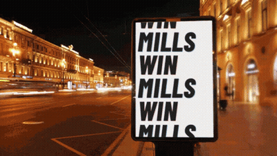 A Sign That Says " Mills Win Mills Win Mills " On It GIF