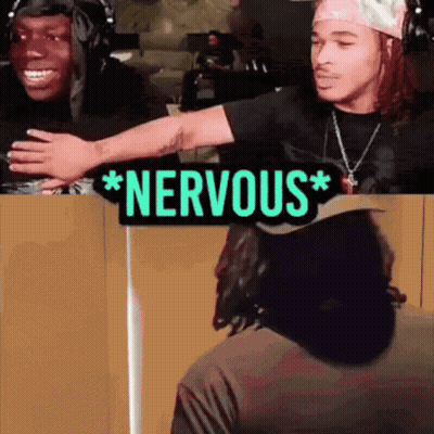 A Sign That Says Nervous On It Next To Two People GIF