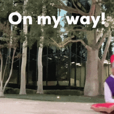 A Sign That Says On My Way In Front Of A Building GIF