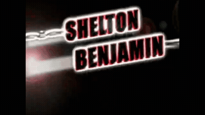 A Sign That Says Shelton Benjamin With A Chain Behind It GIF