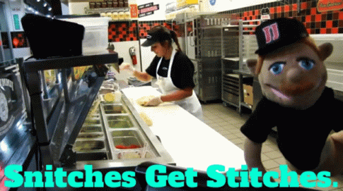 A Sign That Says Snitches Get Stitches With A Puppet In The Background GIF