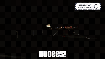 A Sign That Says Spend $ 100 At Buc-Ee 'S Is Above A Dark Highway GIF