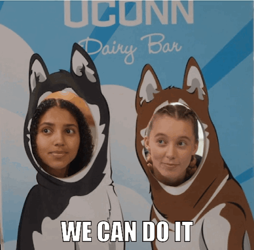 A Sign That Says Uconn Dairy Bar With Two Girls Standing In Front Of It GIF