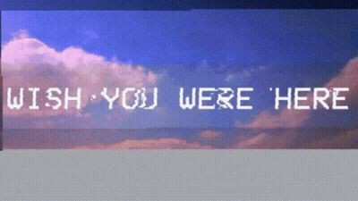 A Sign That Says Wish You Were Here In Front Of A Cloudy Sky GIF