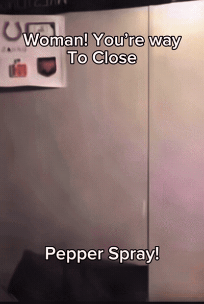 A Sign That Says Woman You 'Re Way To Close Pepper Spray On It GIF