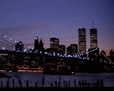 A Silhouette Of A City Skyline With The Twin Towers In The Background GIF