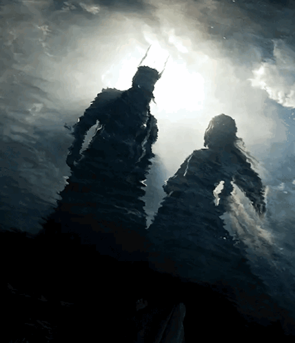 A Silhouette Of A Man And Woman In The Water GIF