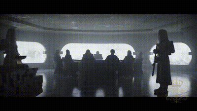 A Silhouette Of A Man Holding A Gun Standing In Front Of A Group Of People . GIF