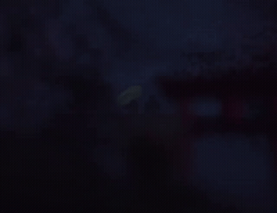 A Silhouette Of A Man Holding An Umbrella Standing On A Bridge GIF
