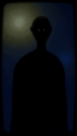 A Silhouette Of A Man In A Hat Walking In The Dark GIF