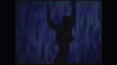 A Silhouette Of A Man In A Suit With His Arms Outstretched . GIF