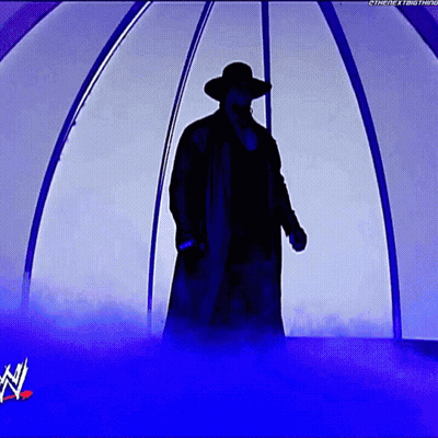 A Silhouette Of A Man In A Trench Coat And Hat Standing In A Tunnel With A W Logo In The Background GIF