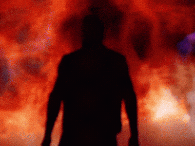 A Silhouette Of A Man Is Standing In Front Of A Red Background GIF