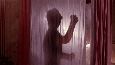 A Silhouette Of A Man Standing Behind A Pink Curtain GIF