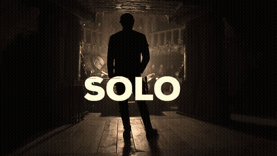 A Silhouette Of A Man Standing In A Dark Room With The Word Solo Behind Him GIF