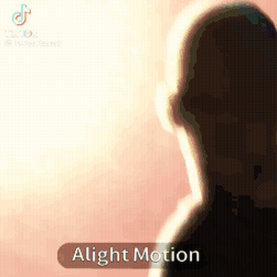 A Silhouette Of A Man Standing In Front Of A Pink Background With The Words Alight Motion On The Bottom . GIF