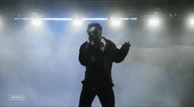 A Silhouette Of A Man Standing In Front Of A Stage With The Word Cancella On The Bottom Right GIF