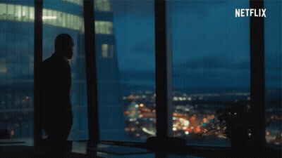 A Silhouette Of A Man Standing In Front Of A Window With Netflix Written In The Corner GIF