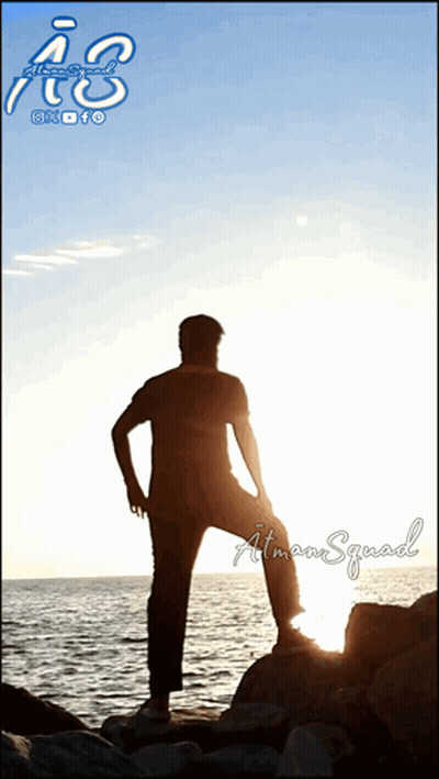 A Silhouette Of A Man Standing On A Rock Overlooking A Body Of Water With The Letters A & S Above Him GIF