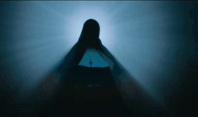 A Silhouette Of A Nun With A Cross On Her Waist GIF