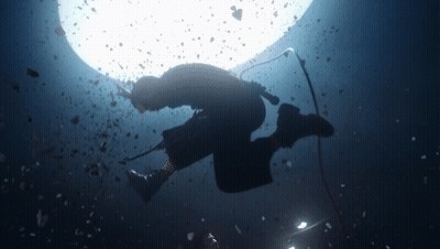 A Silhouette Of A Person Holding A Microphone Underwater GIF