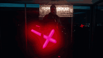 a silhouette of a person in a dark room with a blue light behind him