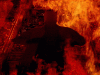 A Silhouette Of A Person In A Dark Room With Fire Behind Them GIF