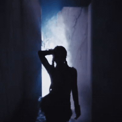 A Silhouette Of A Person In A Dark Room With Smoke Coming Out Of The Doorway GIF