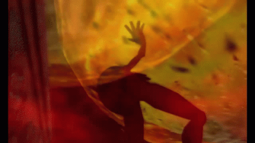 A Silhouette Of A Person Is Behind A Curtain With A Hand Reaching Out GIF