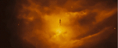A Silhouette Of A Person Standing In A Dark Cloudy Sky GIF